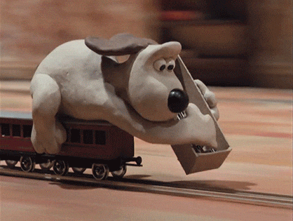 Gromit frantically lays down train tracks just ahead of a speeding locomotive. From Wallace & Gromit: The Wrong Trousers (1993).